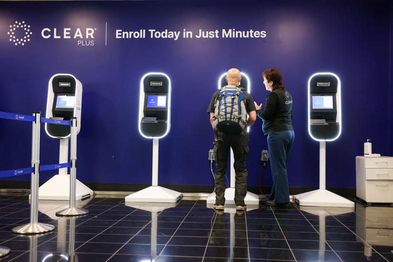 A traveler gets help from a Clear Plus ambassador for faster check-in at the TSA security line at the Oakland International Airport in Oakland, Calif., on Wednesday, May 1, 2024.