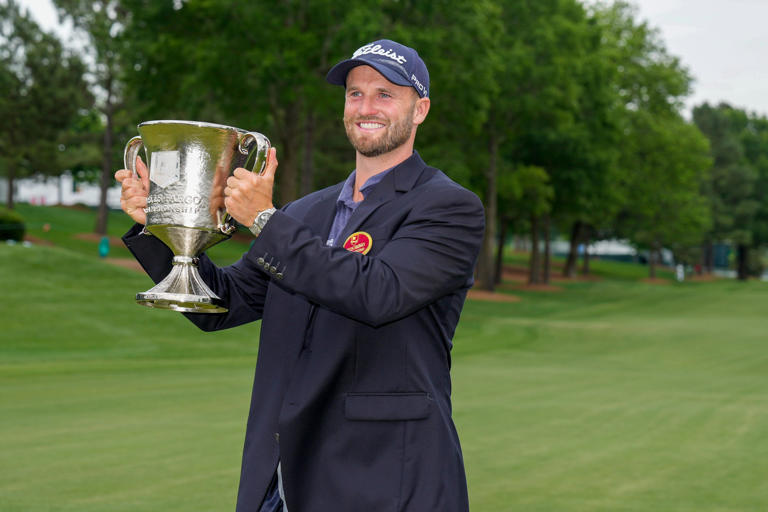 May 7, 2023; Charlotte, North Carolina, USA; Wyndham Clark hoists his trophy after his win during the final round of the Wells Fargo Championship golf tournament. Mandatory Credit: Jim Dedmon-USA TODAY Sports