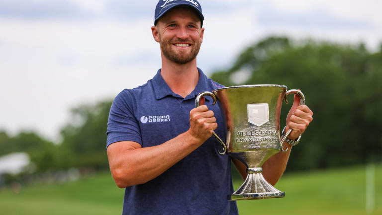 Wyndham Clark poses with the trophy after winning the 2023 Wells Fargo Championship.