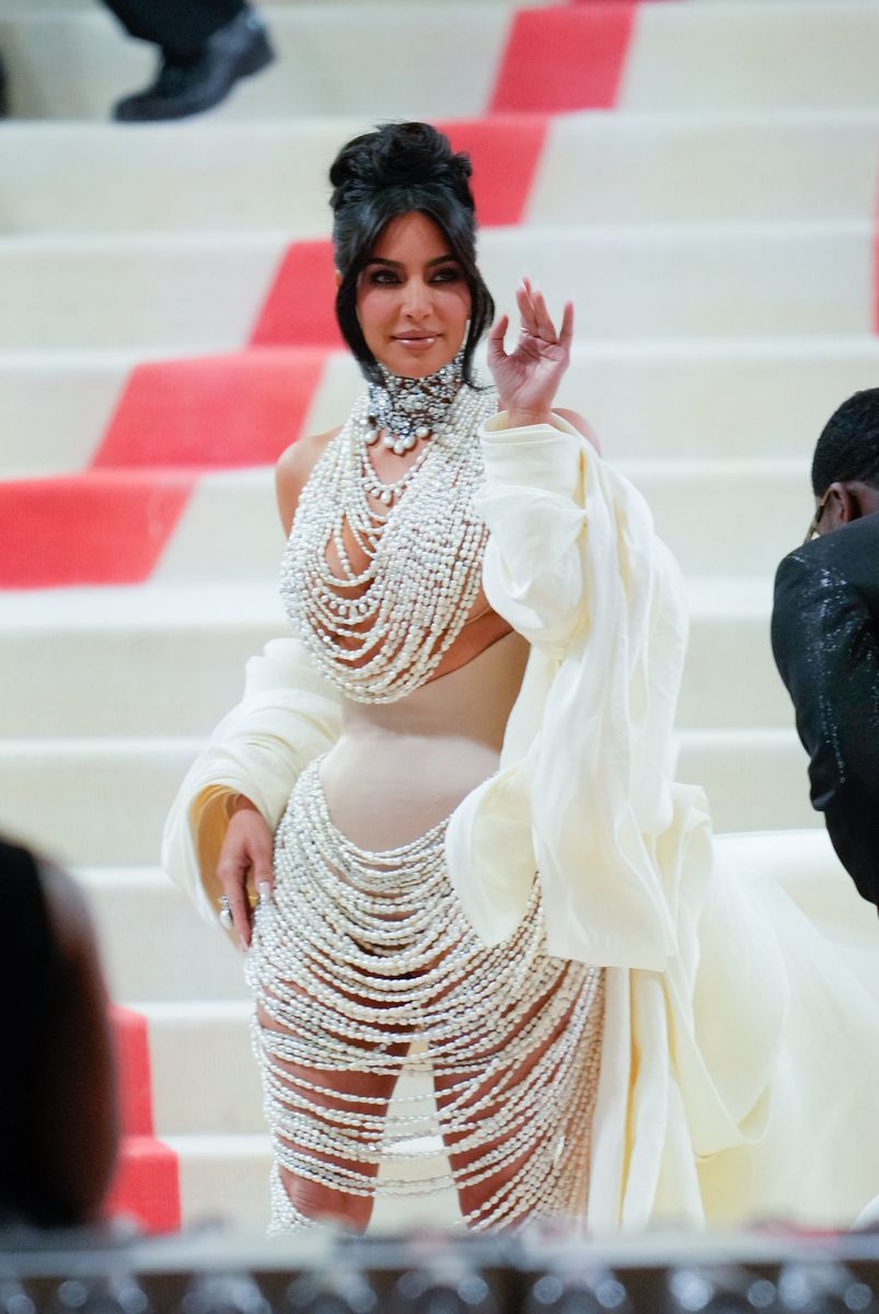 kim kardashian pairs a metallic ﻿maison margiela corset with a cozy cardigan at the met gala﻿