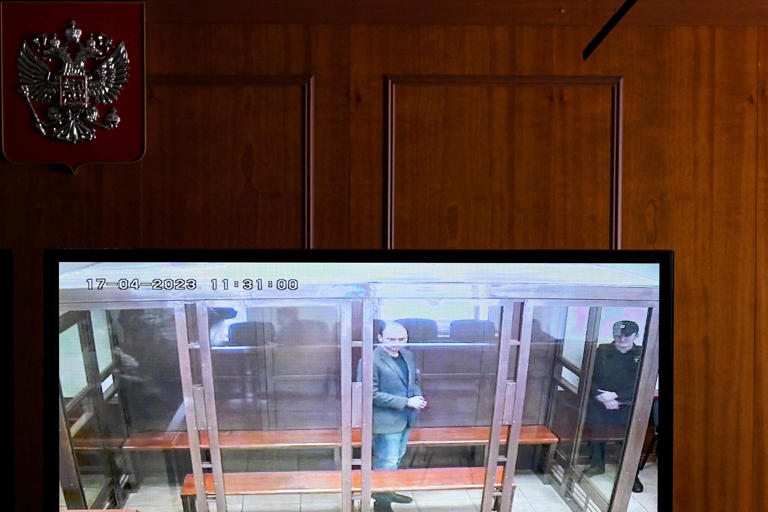 A screen set up at a hall of the Moscow City Court shows live feed of the verdict in the case against Russian opposition figure Vladimir Kara-Murza, who is accused of treason and spreading "false" information about the Russian army, in Moscow on April 17, 2023.
