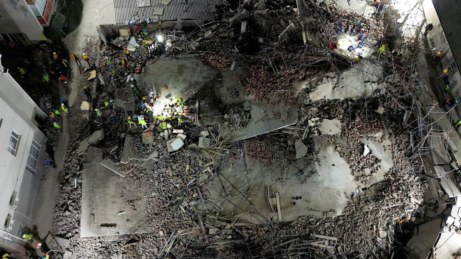 at least three dead and dozens more trapped after multi-storey building collapses