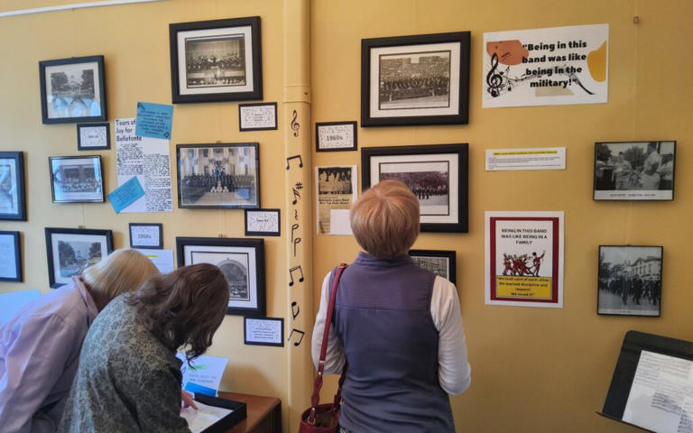 Visitors view photographs and a scrapbook inside the American Legion Junior Band Exhibit at the Historical Museum. Photo courtesy Centre County Library and Historical Museum