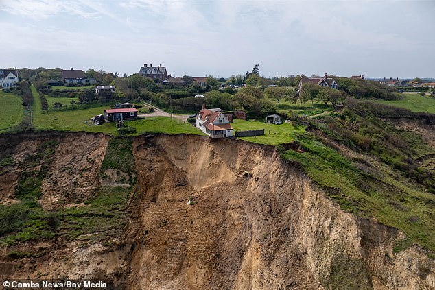 drone footage shows norfolk home close to collapsing as cliff crumbles