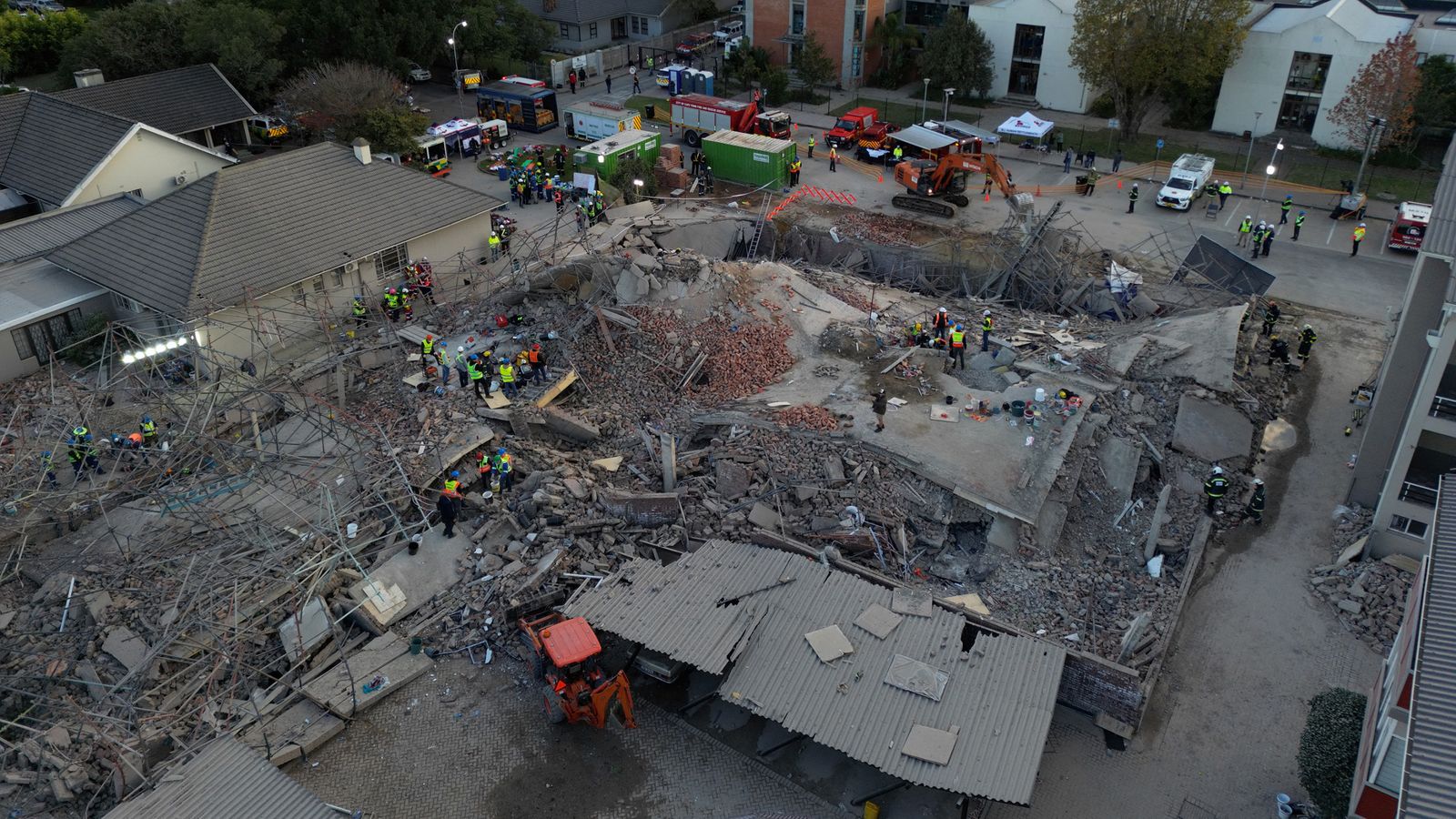 at least five dead and dozens more trapped after multi-storey apartment building collapses