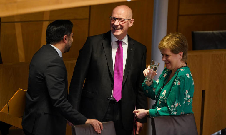 John Swinney (centre) shares a laugh with the former first ministers Humza Yousaf and Nicola Sturgeon after the vote on Tuesday. Photograph: Andrew Milligan/PA