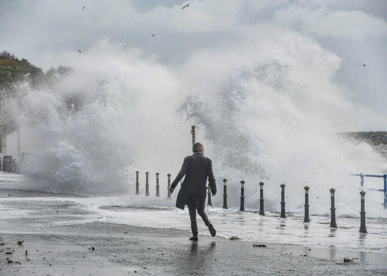 Waves crash over the seafront in Whitehead in Northern Ireland