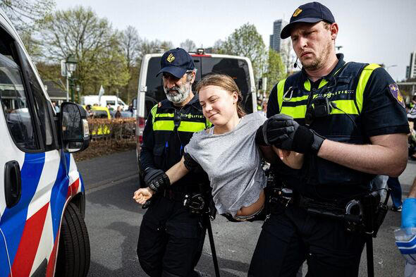 Greta Thunberg carried by police officers 
