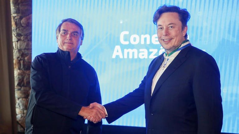 Elon Musk being awarded the Defense Order of Merit medal as he shakes hands with Brazil’s then-president Jair Bolsonaro, in Porto Feliz, Brazil on May 20, 2022. 