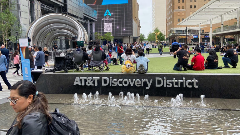 Crowds being to fill the AT&T Discovery District in downtown Dallas on eclipse day, April 8, 2024.