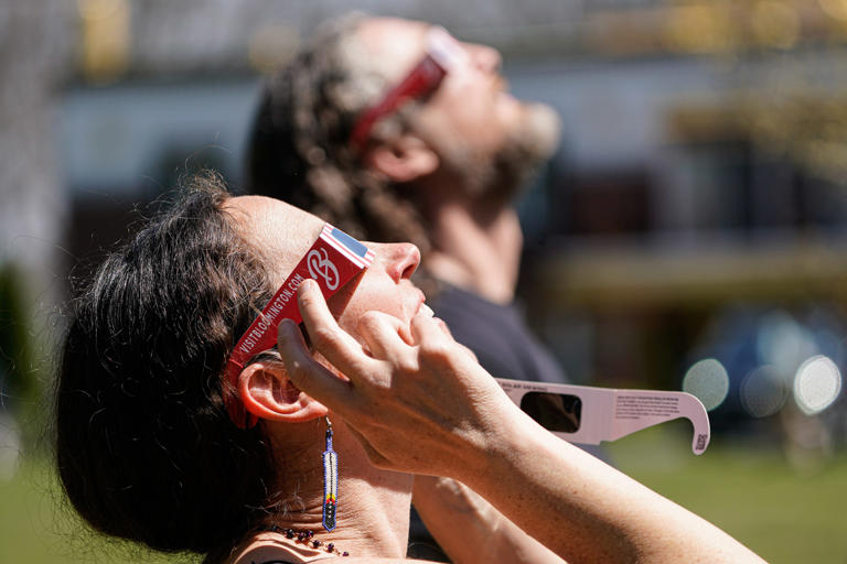 Dex and Kelly Conaway watch the eclipse at the Tibetan Mongolian Buddhist Cultural Center and Kumbum Chamtse Ling Monastery on Monday, April 8, 2024, in Bloomington Indiana.