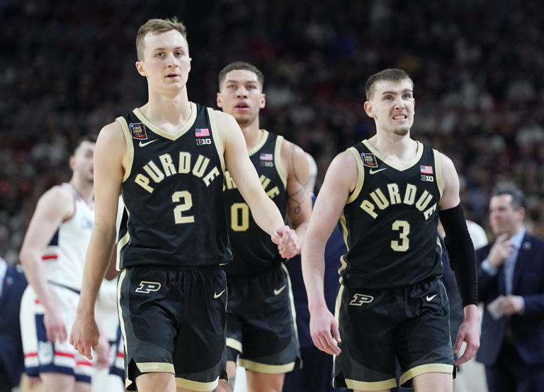 Purdue Boilermakers guard Fletcher Loyer (2), Purdue Boilermakers forward Mason Gillis (0) and Purdue Boilermakers guard Braden Smith (3) walk back to the Purdue Boilermakers bench during a timeout during the NCAA Men’s Basketball Tournament Championship against the Connecticut Huskies, Monday, April 8, 2024, at State Farm Stadium in Glendale, Ariz.