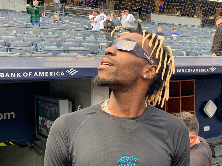 Photos See Marlins players watch the solar eclipse before series