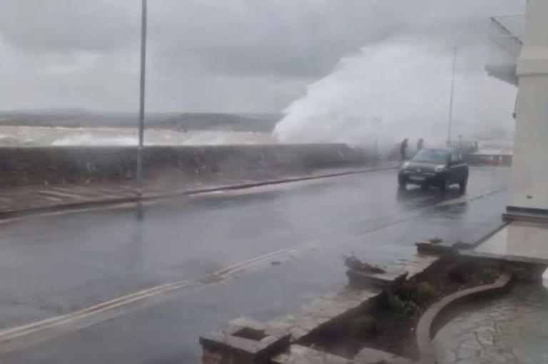 Dramatic video shows storm waves crash over sea wall and drench passers-by