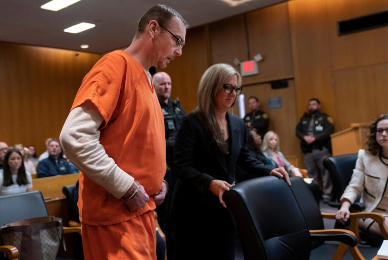 James Crumbley, left, enters court as he prepares to sit with his attorney Mariell Lehman in the Oakland County courtroom of Cheryl Matthews on Tuesday, April 9, 2024 for sentencing.