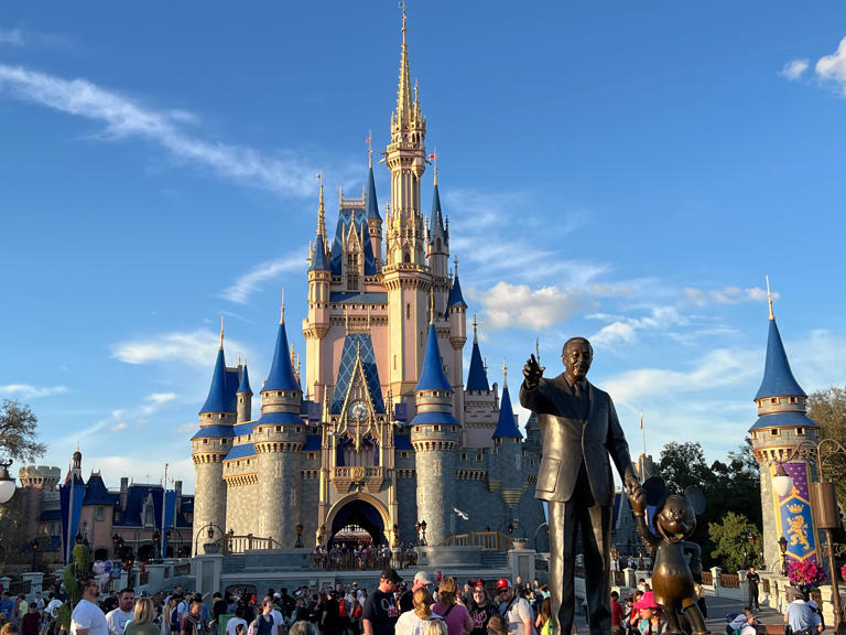 Walt Disney and Mickey Mouse appear to survey Magic Kingdom in the iconic Partners statue at Walt Disney World.