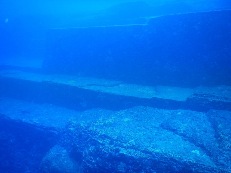 <p>The Yonaguni monument was first discovered by Kihachiro Aratake in 1986. Aratake was in the water hoping to see Hammerhead sharks. Instead, he found a monument that has become an incredibly popular diving location.</p> <p>The monument, thought by some to be an ancient lost city, is estimated to be 5,000-8,000 years old. There is also a debate over whether the monument was naturally occurring or carved. The only way to tell is by getting down there yourself.</p>