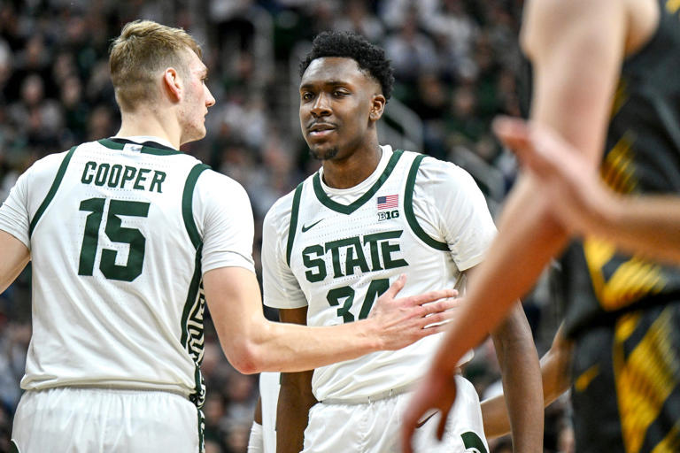 Michigan State's Xavier Booker, right, celebrates with Carson Cooper after Booker was fouled and made a shot against Iowa during the first half on Tuesday, Feb. 20, 2024, at the Breslin Center in East Lansing.
