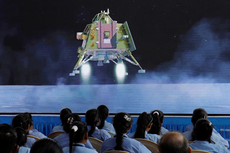 People watch a live stream of Chandrayaan-3 spacecraft's landing on the moon, inside an auditorium of Gujarat Science City in Ahmedabad, India, August 23, 2023. (Reuters)