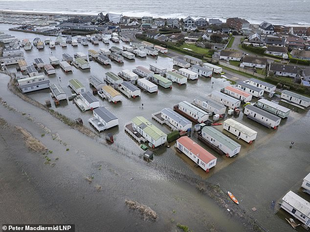 families face horrendous clean-up after high tide flooded their homes - turning gardens into swimming pools and writing off 15 cars