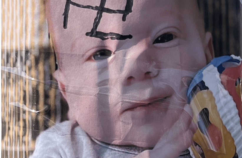 swastika drawn on poster of baby and other hamas hostages in toronto park
