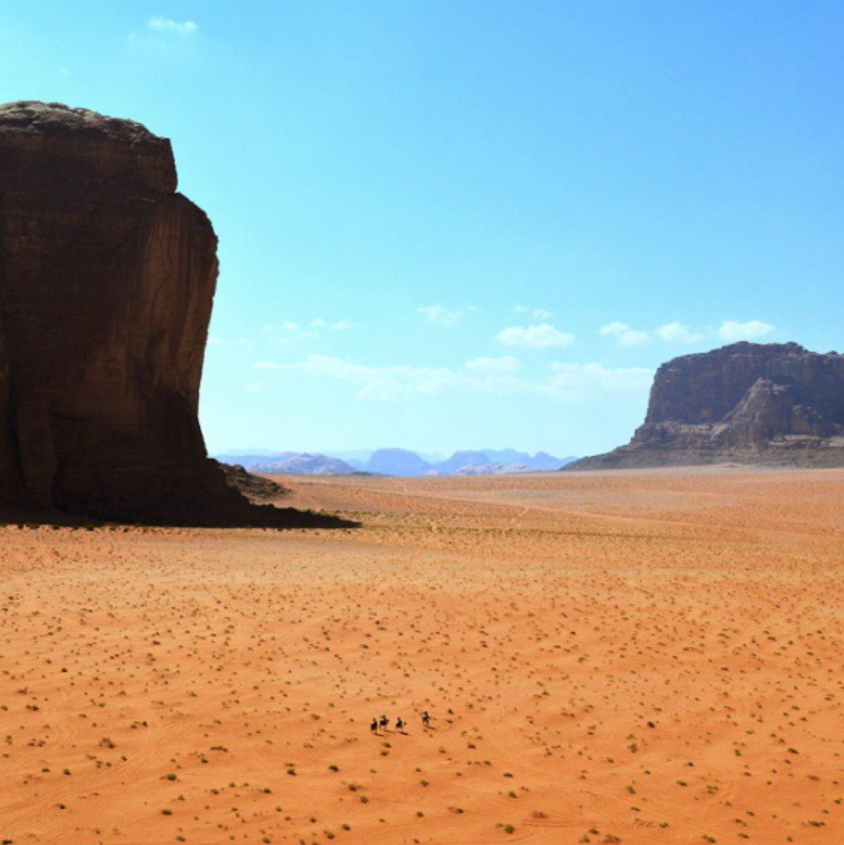 <p>Here is a picture of some people traveling in the Jordanian desert.</p> <p>If you squint closely, you'll be able to see the four people riding their horses in the sand. </p>