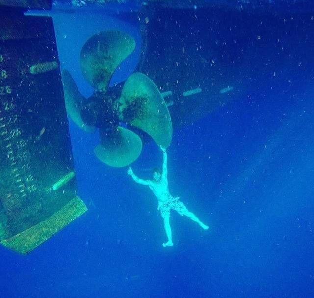 <p>Here's a diver posing next to a MASSIVE propellor. I hope that they didn't start it accidentally or anything, because yikes. </p> <p>Pictures like these just go to show that we are so tiny in comparison to the machinery that we build. </p>