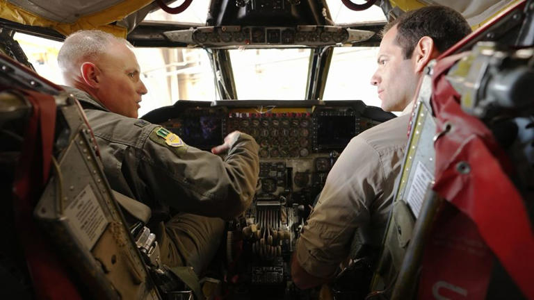 Col. Michael Maginness, commander of the 2nd Bomb Wing, shows CNN's Oren Liebermann, right, the cockpit of a B-52H. - CNN