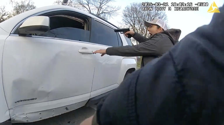 A still image of a video released by the Civilian Office of Police Accountability shows a group of Chicago police officers surrounding a vehicle driven by Dexter Reed, 26, moments before an "exchange of gunfire" in which Reed was fatally shot on March 21, 2024 in the Humboldt Park neighborhood.