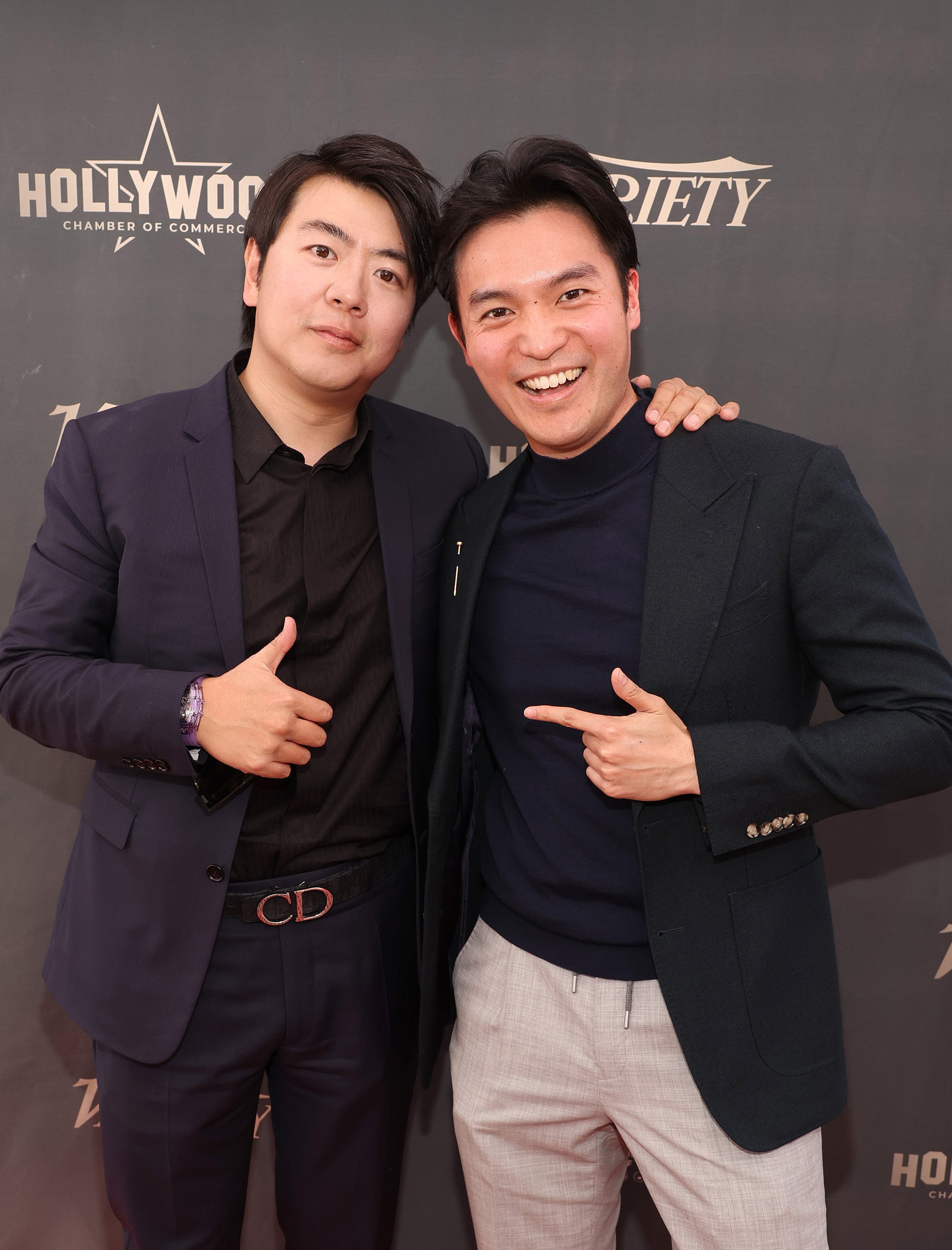 Lang Lang, left, and Taiwanese Australian violinist Ray Chen link up for a photo at the pianist's induction ceremony.
