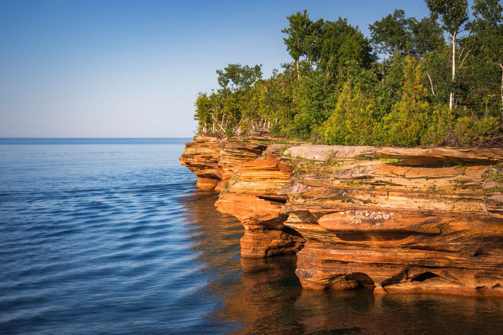 <p class="wp-caption-text">Image Credit: Shutterstock / Gottography</p>  <p><span>Located in Lake Superior, the Apostle Islands are known for their historic lighthouses, sandstone sea caves, and pristine natural beauty. It’s an extraordinary destination for kayaking, exploring, and connecting with nature on the freshwater sea.</span></p>