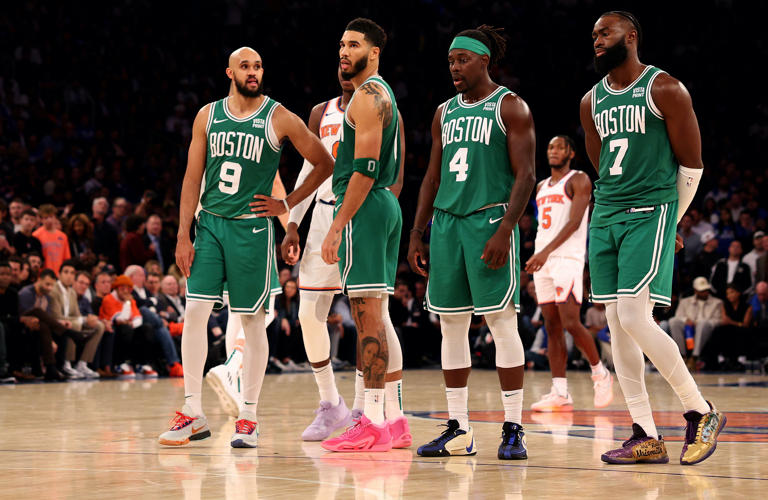 Jalen Brunson #11 of the New York Knicks attempts a free throw as Derrick White #9, Jayson Tatum #0, Jrue Holiday #4 and Jaylen Brown #7 of the Boston Celtics look on at Madison Square Garden on October 25, 2023 in New York City. Holiday just signed a lucrative contract extension.