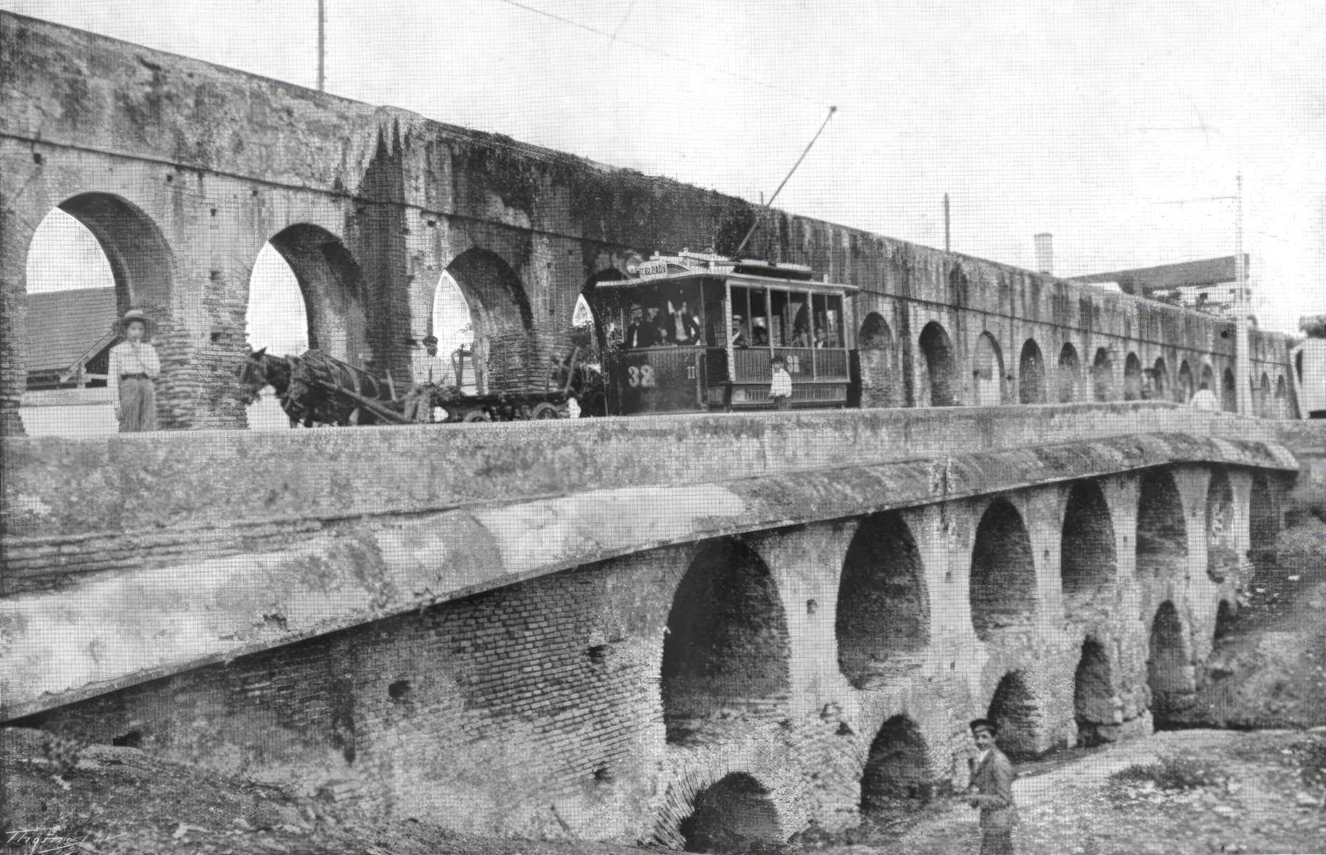 <p>The Canos de Carmona is a Roman aqueduct built during the first century BC to supply spring water to the ancient Roman city of Hispalis, or modern-day Seville. In its heyday it transported around 177,000 cubic feet of water and was still being used until 1912, well after this photo was taken. It was demolished after locals complained it was being used as a haven for criminals, and today only three small segments survive.</p>