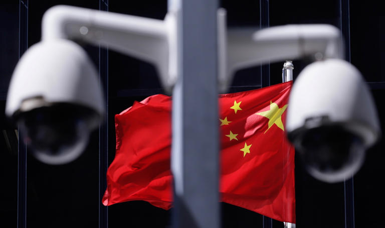 Photo of CCTV cameras in front of a Chinese flag