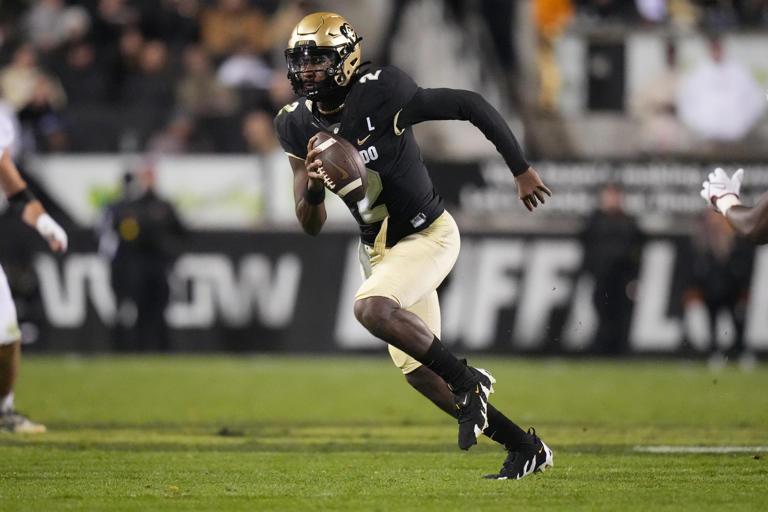 Colorado Buffaloes quarterback Shedeur Sanders (2) scrambles with the ball during a game against the Stanford Cardinal on Oct. 13, 2023.