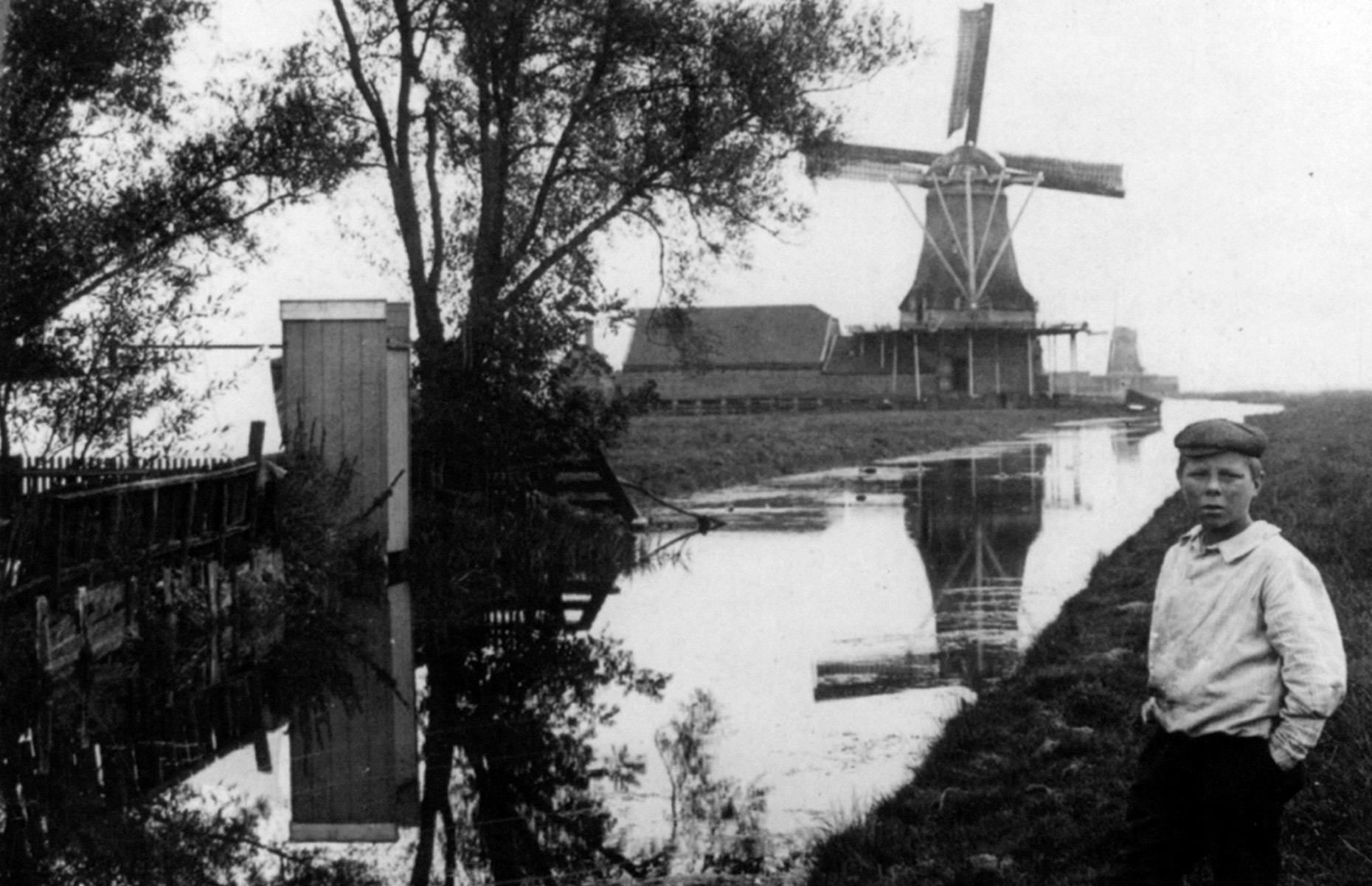 <p>For visitors to rural areas like Zaandijk in Zaanstad, traditional windmills make for an evocative backdrop to their holiday photos, especially if they are surrounded by tulips. But when this photo was taken in 1900, they were used to help control and prevent flooding in the region, pumping water out of the lowlands and back into the rivers beyond the dikes so that workers like this young lad could farm the land.</p>