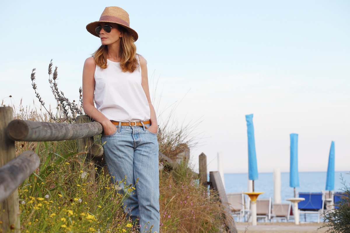 <p>Rizzo says this is "one of the most versatile items you can have in your wardrobe."</p><p>"A white tank top is the perfect piece to wear solo or layered underneath another item," she shares. "It's the perfect mix of cool and casual while able to be dressed up with some dainty jewelry and statement accessories."</p><p>Better yet, grab a few tanks and tees "in all your staple wardrobe colors," Foster suggests. (This color range is actually another crucial aspect of your summer closet, ensuring everything works together.)</p><p>"Choose your summer color palette and do your very best to stick to it. This will ensure everything goes and make packing an absolute snap," Foster explains, using the examples of white, khaki, and navy with red accessories, or black and white with metallic accessories.<p><strong>RELATED: <a rel="noopener noreferrer external nofollow" href="https://bestlifeonline.com/how-to-get-out-of-a-clothing-rut/">10 Tips for Getting Out of a Clothing Rut After 60, Stylists Say</a>.</strong></p></p>