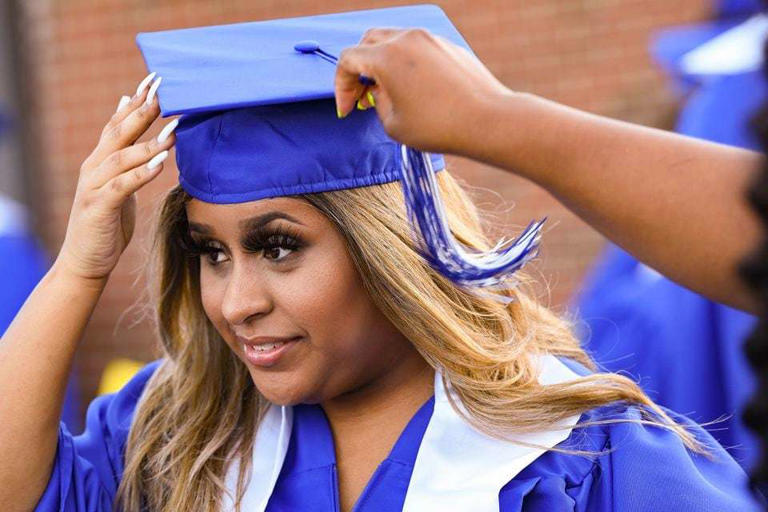 Auburn High School graduate Analiah Wilkerson gets a little help adjusting her cap as she prepares to walk Thursday, May 20, 2021, before graduation ceremonies at Duck Samford Park in Auburn, Ala.