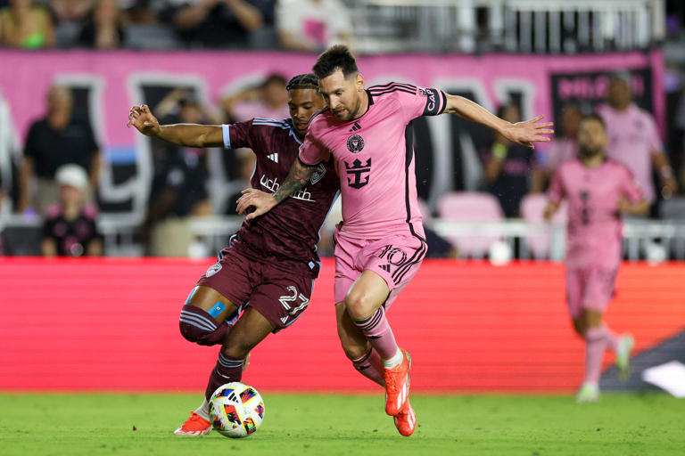 Apr 6, 2024; Fort Lauderdale, Florida, USA; Inter Miami CF forward Lionel Messi (10) and Colorado Rapids forward Kimani Stewart-Baynes (27) battle for the ball in the second half at Chase Stadium. Mandatory Credit: Nathan Ray Seebeck-USA TODAY Sports