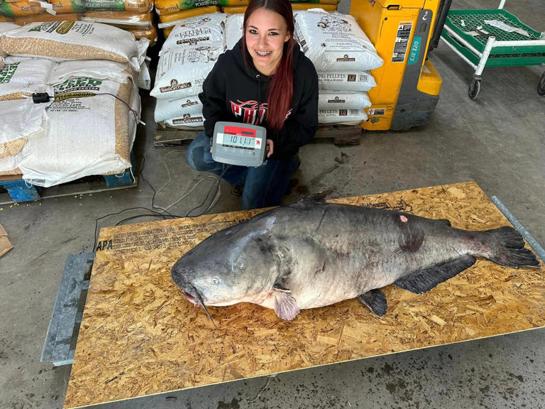 Jaylynn Parker poses with the 101.11 pound catfish she landed on the Ohio River on April 7, 2024.