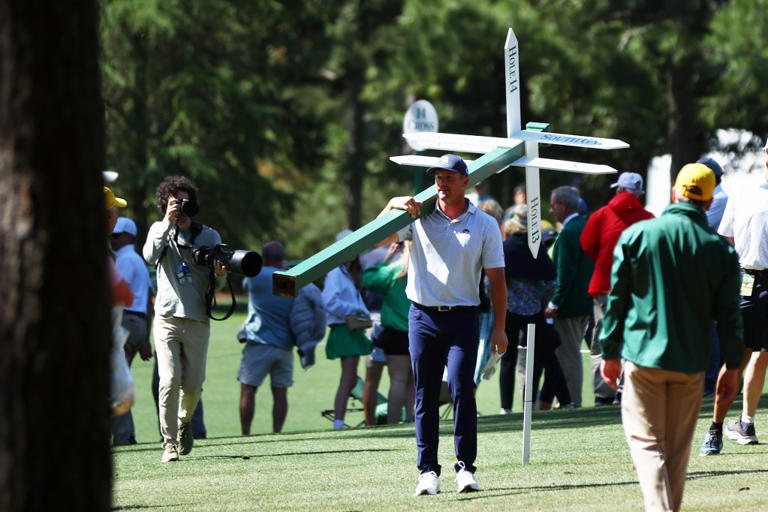 Bryson DeChambeau seen wildly walking at Masters carrying Augusta signpost