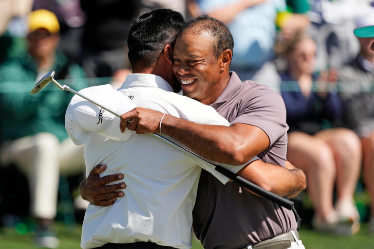 Jason Day greets Tiger Woods on the 18th green in the second round.