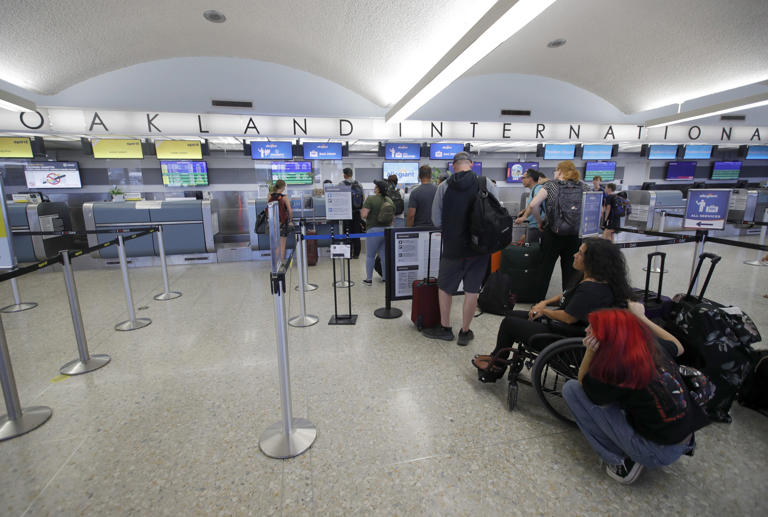 Passengers check in at Oakland International Airports Terminal 1 in Oakland, Calif., on Monday, July 24, 2023. Airport officials recently voted to add 'San Francisco Bay' to its name, angering the city of San Francisco.