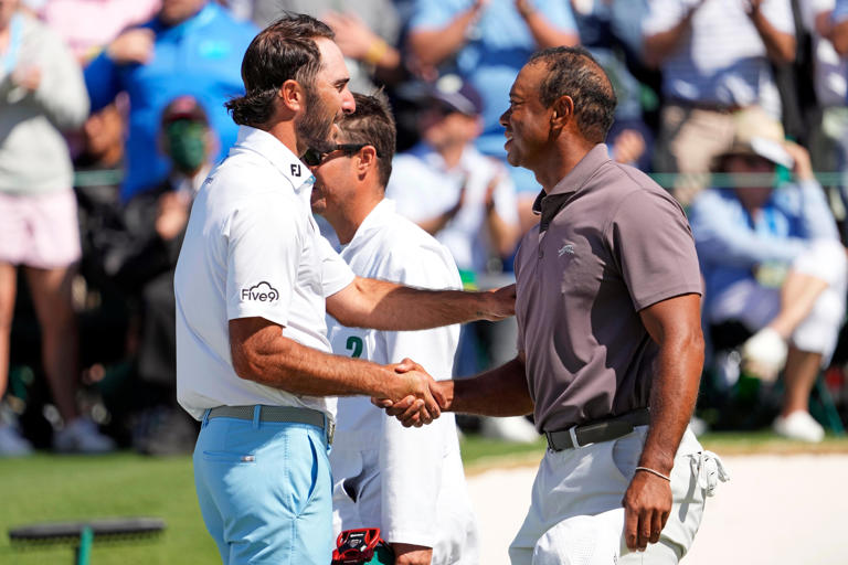 Round 2: Max Homa greets Tiger Woods on the 18th green following their rounds.