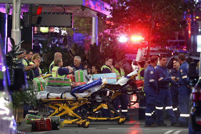 DAVID GRAY/AFP via Getty Paramedics outside the Westfield Bondi Junction shopping mall in Sydney, Australia.