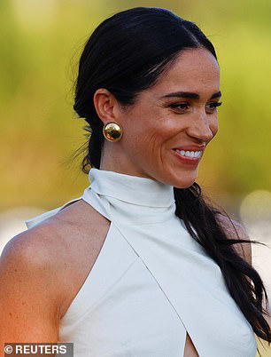 Meghan pairs 'Santa Barbara' sunglasses with £650 silk dress at polo