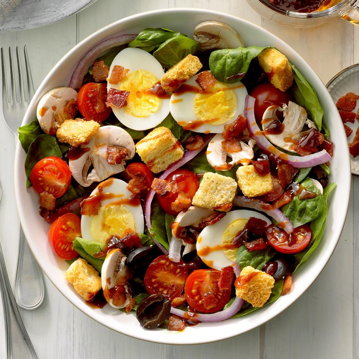<p>After having a salad like this at a restaurant years ago, I came up with this recipe. It is especially good when the spinach comes right from the garden to the table.</p> <div class="listicle-page__buttons"> <div class="listicle-page__cta-button"><a href='https://www.tasteofhome.com/recipes/spinach-salad-with-hot-bacon-dressing/'>Go to Recipe</a></div> </div>