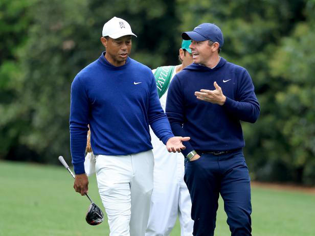 Rory McIlroy and Tiger Woods walk together at the 2023 Masters.