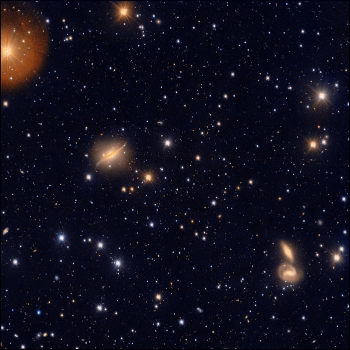 world's largest visible light telescope spies a galaxy cluster warping spacetime