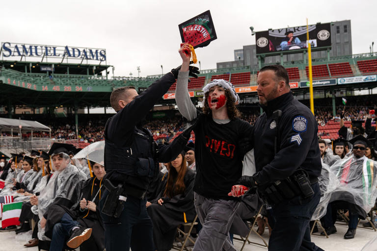 A Northeastern student was confronted by police while protesting during commencement at Fenway Park.